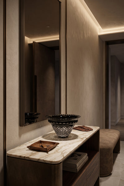 Noctura Crest Bowl on a marble bedroom console beneath a softly lit mirror