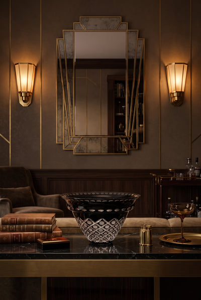 Noctura Crest Bowl on a glass lounge table framed by a mirror and wall lights