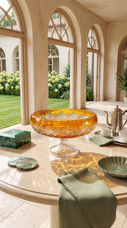 Sunlit Amber Coronet Pedestal Bowl on a sunlit loggia table with pale place settings.