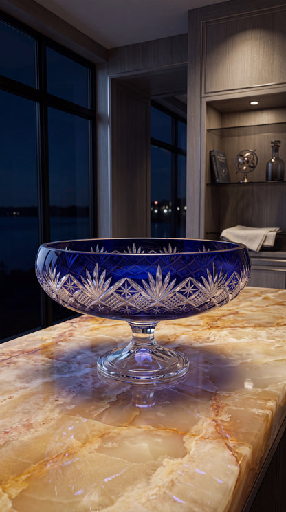 Midnight Sapphire Coronet pedestal bowl on an amber marble counter at night