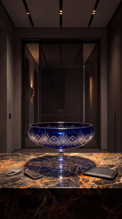 Midnight Sapphire Coronet pedestal bowl on a marble console in a modern entry