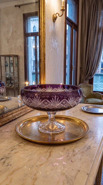 Regal Violet Coronet pedestal bowl on a marble console before a tall mirror