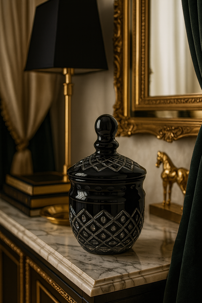 Noctura Obsidian Keepsake Jar on a dark mantel beneath a black shade and gilded mirror.