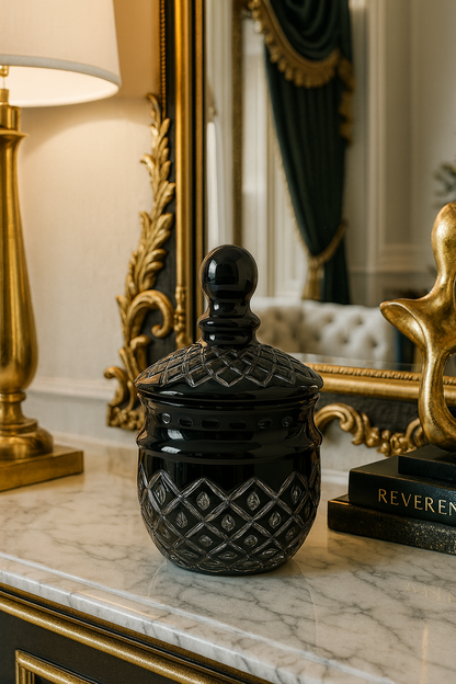 Noctura Obsidian Keepsake Jar on a white marble console beneath a gilded mirror.