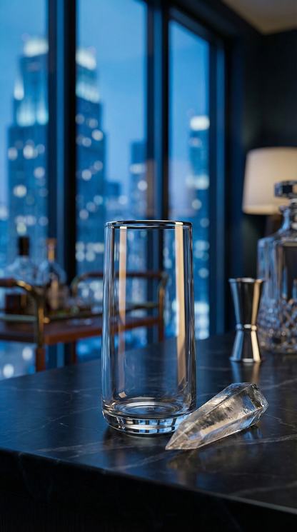 Platora Highball standing empty on a city-view bar beside a jigger and glass stopper.