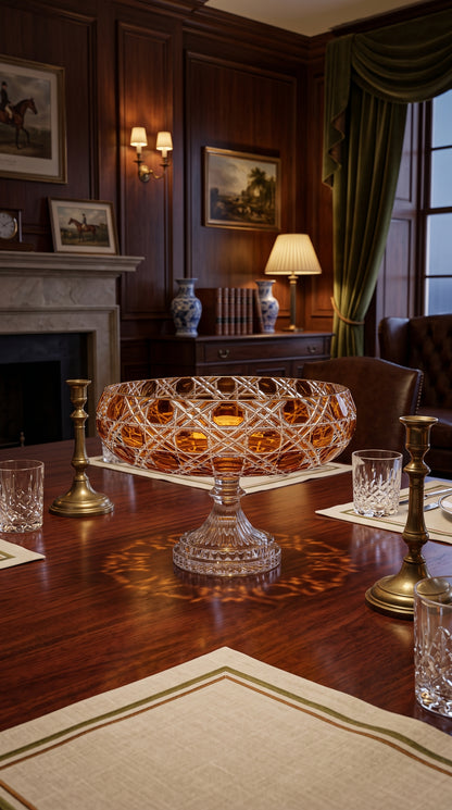 Verdura Sunlit Amber pedestal bowl on a wood table in a lamp-lit library