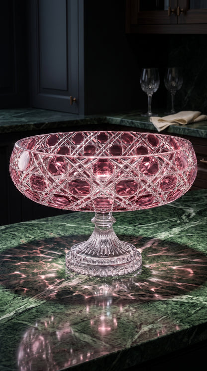 Orchid Rosé Verdura Pedestal Bowl on a dark green marble bar with stemware behind it.