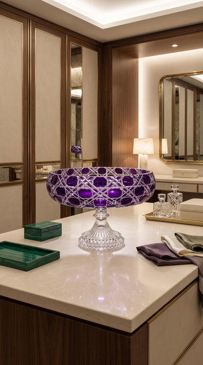 Verdura Regal Violet pedestal bowl on a bright vanity counter beside folded linens